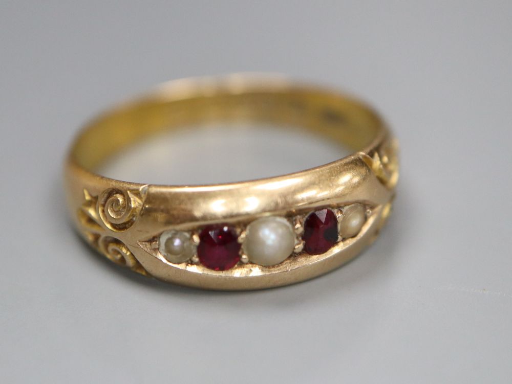 A late Victorian 15ct gold, graduated ruby and split pearl set five stone ring, size M/N, gross 2.8 grams.